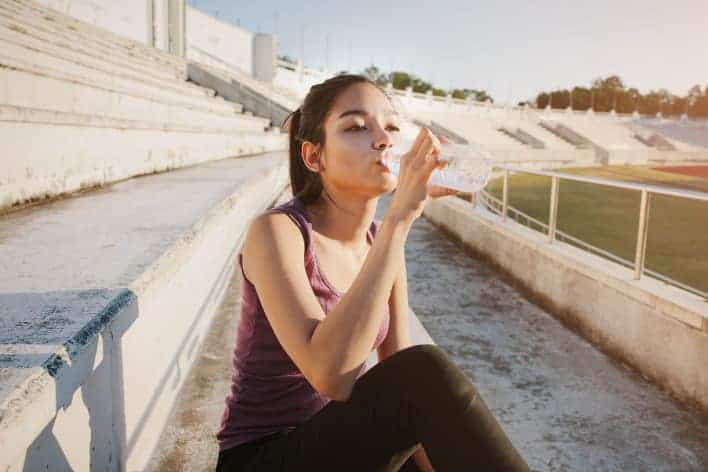 Sportlerin trinkt Wasser nach dem Workout.